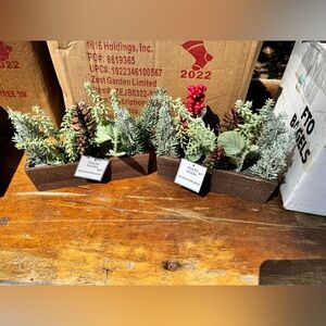 A case of Festive Faux Greenery Arrangements